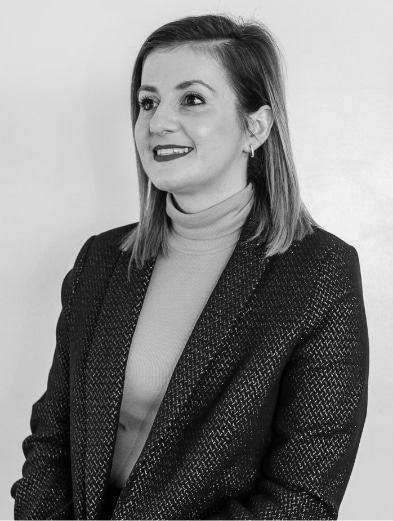 Lisa Nieuwoudt, Mint's Accounting Administrator smiling, in black and white.
