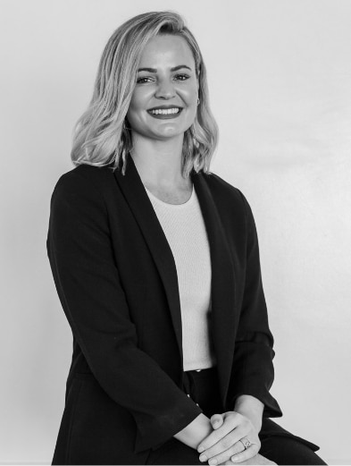 Marisca de Bruyn, Mint's CEO and Founder, smiling, in black and white.